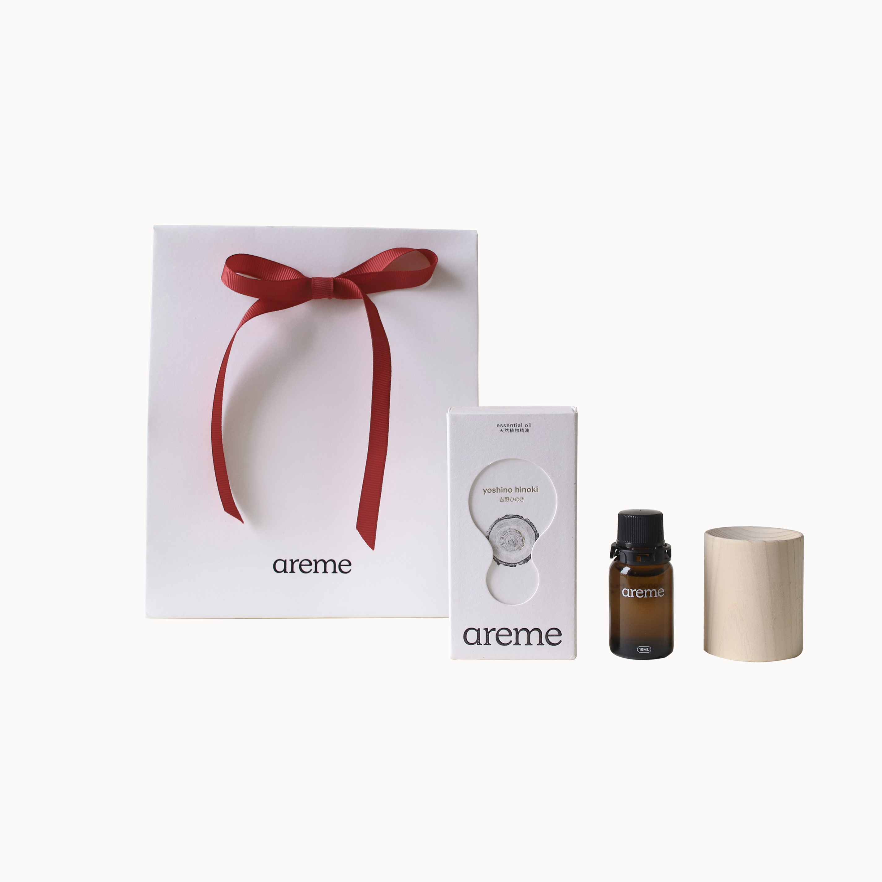 areme aroma product set with a gift box, essential oil bottle, and wood diffuser block on a white background