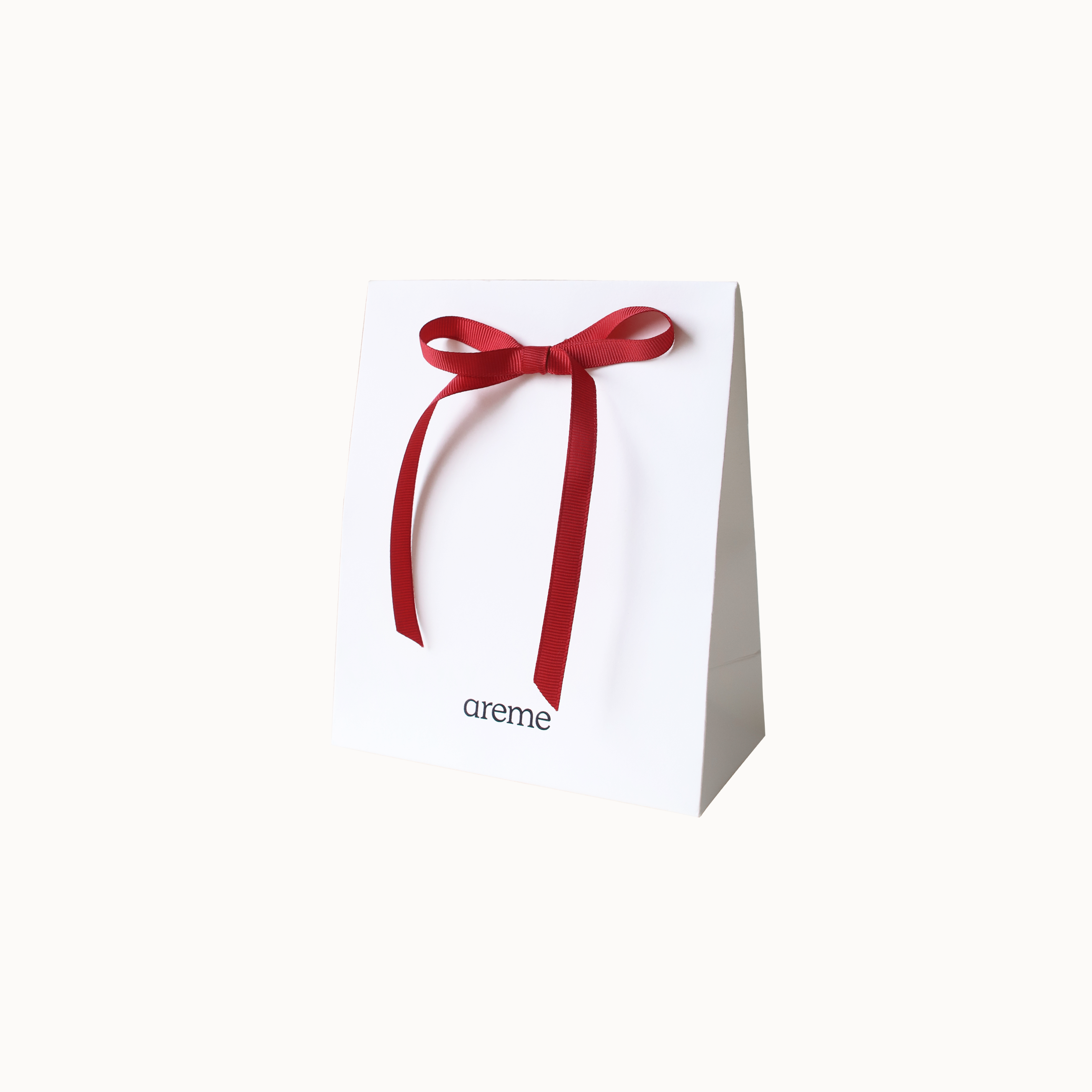 White gift box with a red ribbon and 'areme' branding on a white background