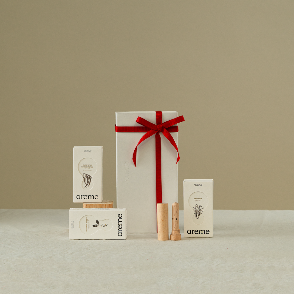 Gift set with a red ribbon and 'areme' branding on a beige background