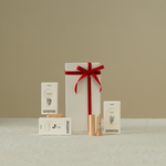 Gift set with a red ribbon and 'areme' branding on a beige background